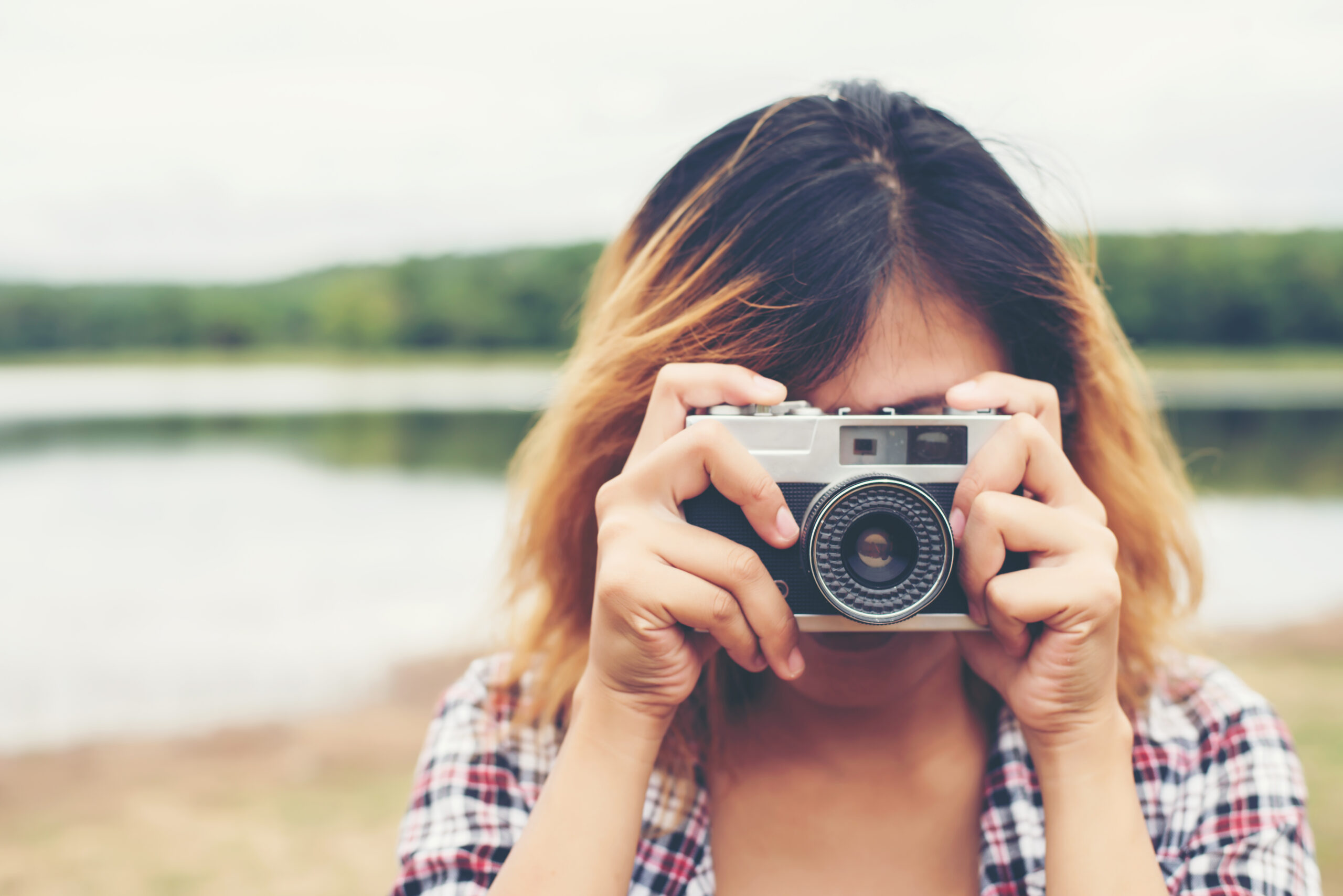 Young hipster beautiful women photography standing shooting retro camera with nature enjoy and happy.